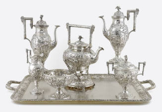 A seven-piece tea and coffee service embellished with repousse flowers and alpine village scene…